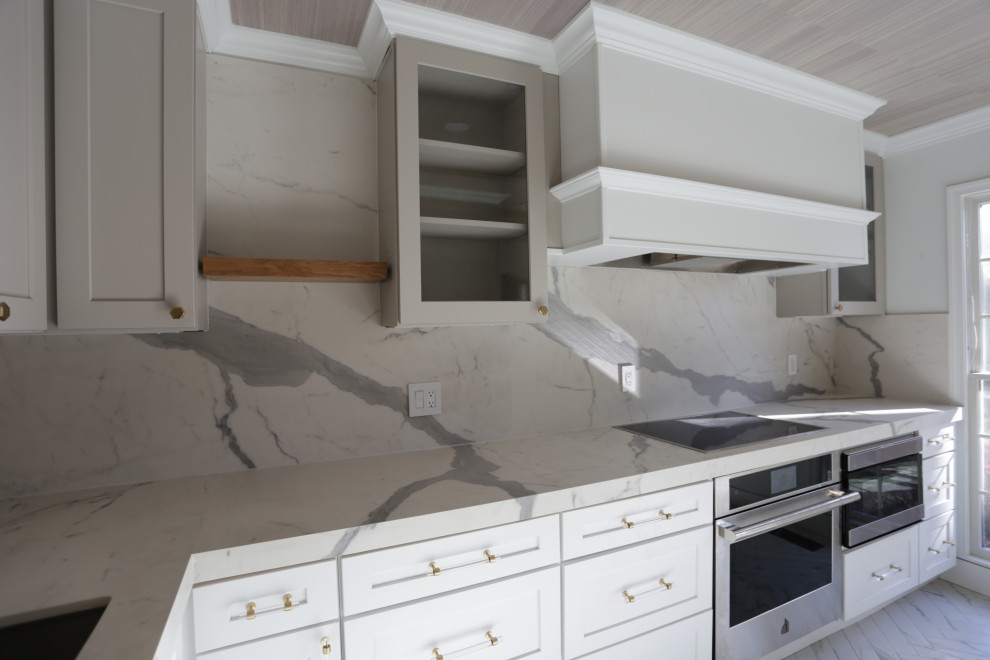 Inspiration for a mid-sized transitional l-shaped marble floor, white floor and exposed beam kitchen remodel in DC Metro with an undermount sink, shaker cabinets, white cabinets, quartzite countertops, white backsplash, quartz backsplash and stainless steel appliances