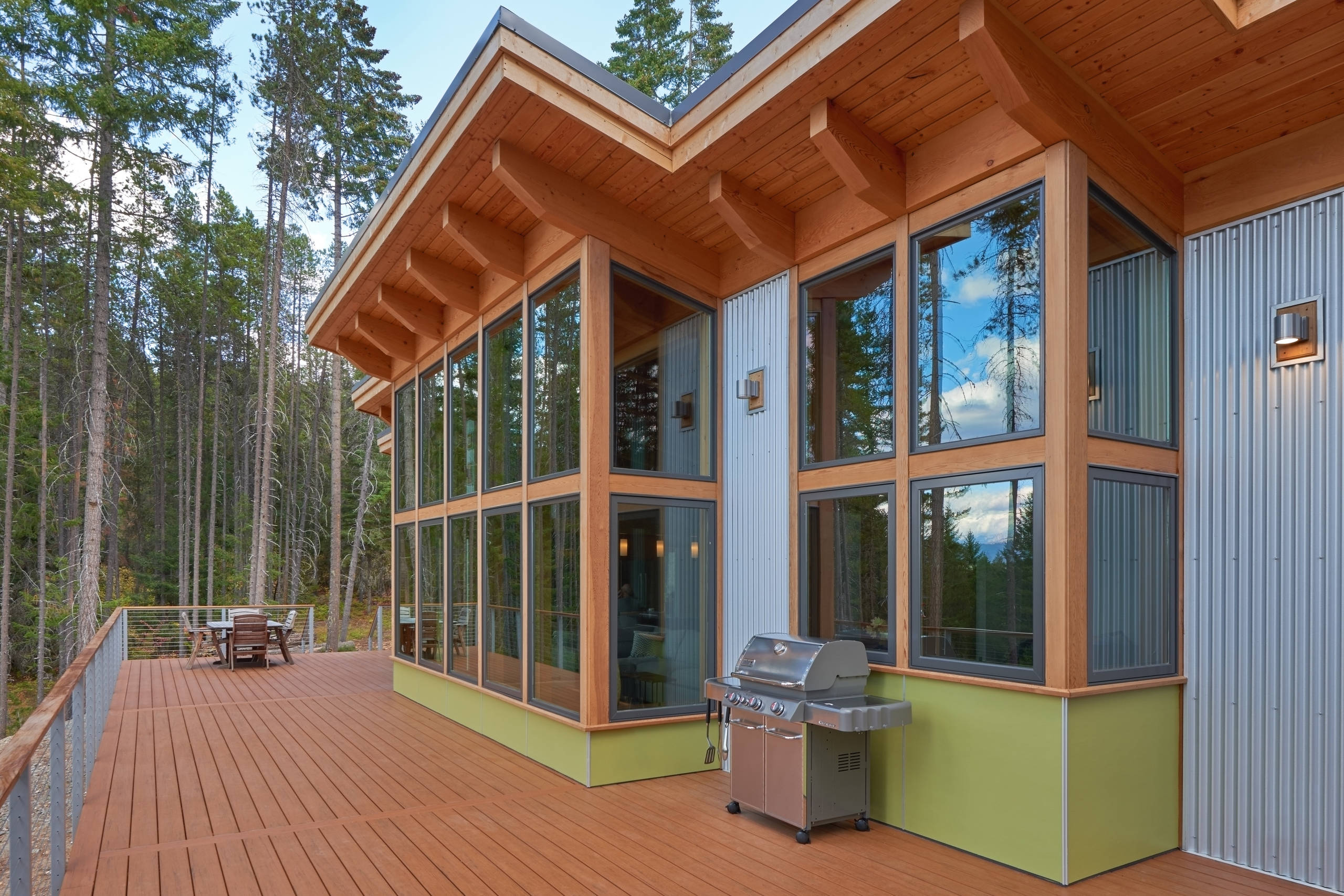 A cedar deck runs the length of the window wall.