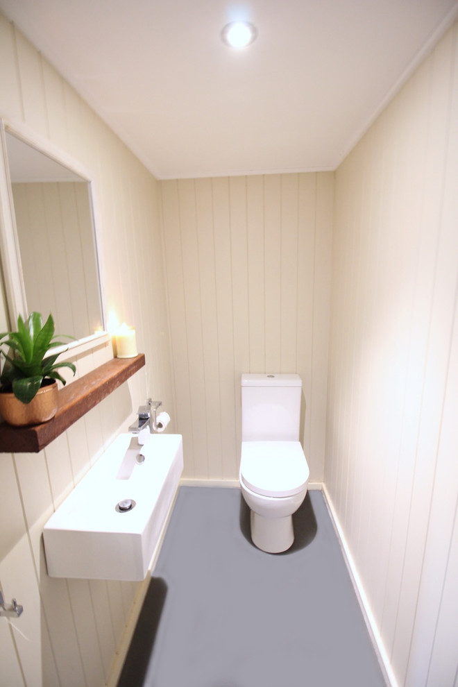 Photo of a small contemporary powder room in Brisbane with concrete floors.