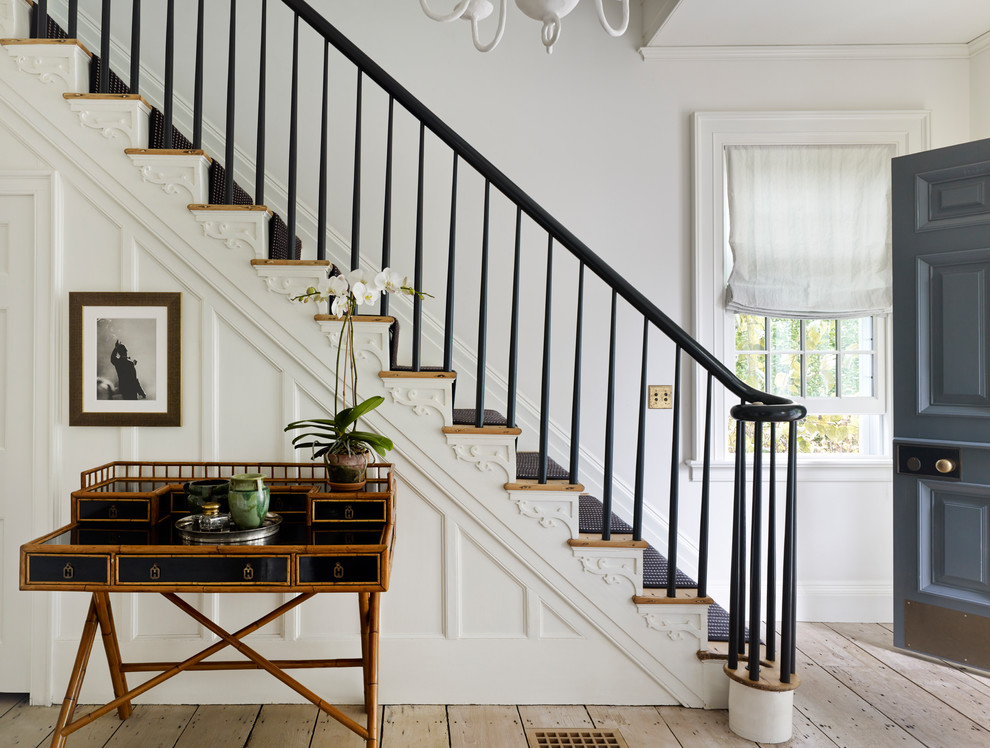Design ideas for a mid-sized traditional carpeted straight staircase in New York with wood risers and wood railing.