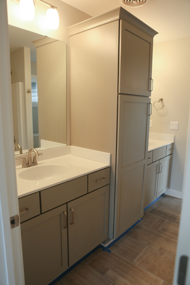 Example of a mid-sized transitional master beige tile and porcelain tile porcelain tile home design design in Chicago with shaker cabinets, gray cabinets, a two-piece toilet, gray walls, a drop-in sink and marble countertops