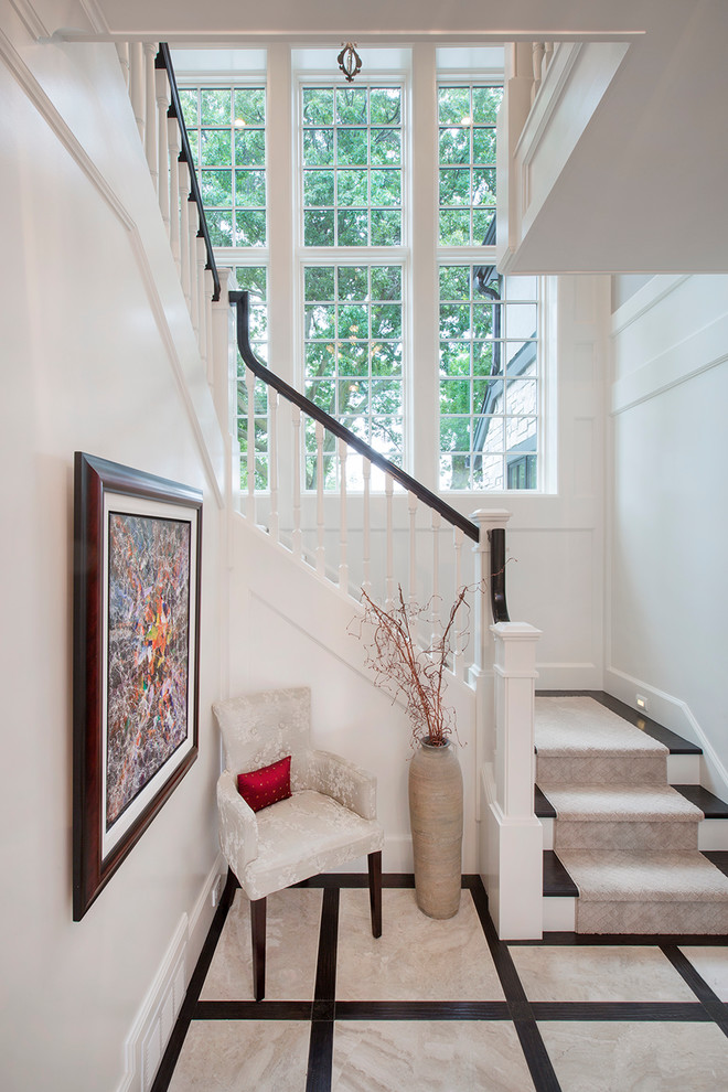 Foyer - transitional marble floor foyer idea in Omaha with white walls and a white front door