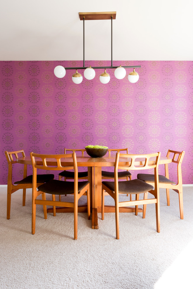 This is an example of a mid-sized midcentury separate dining room in Los Angeles with pink walls, carpet, no fireplace and beige floor.