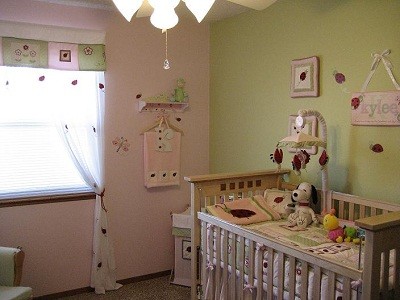 Design ideas for a mid-sized transitional nursery for girls in Denver with pink walls and carpet.