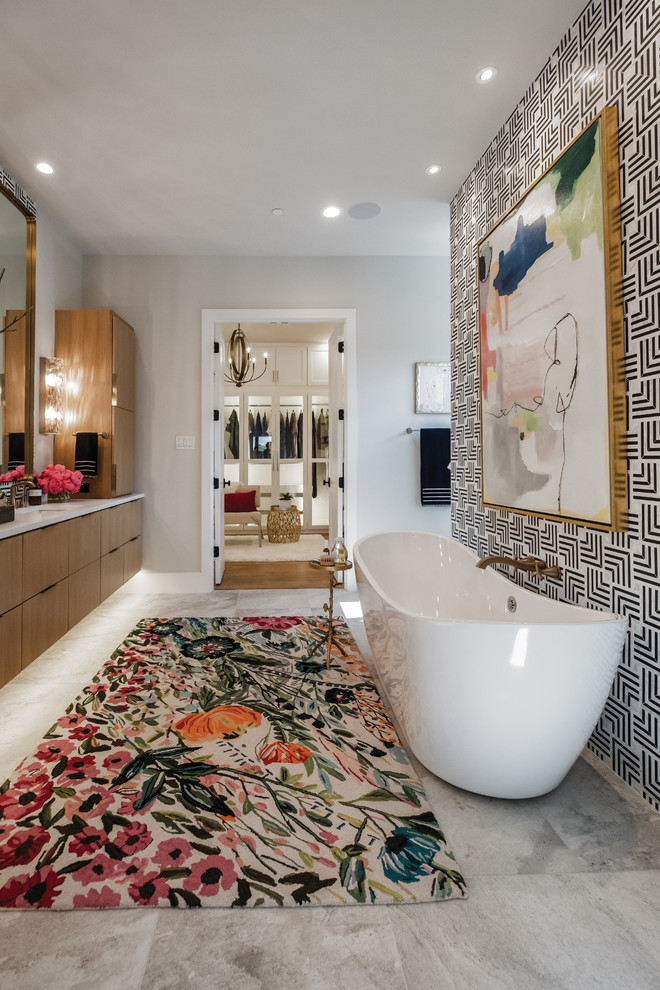 Photo of a large eclectic master bathroom in Dallas with flat-panel cabinets, medium wood cabinets, a freestanding tub, multi-coloured walls, an undermount sink and grey floor.