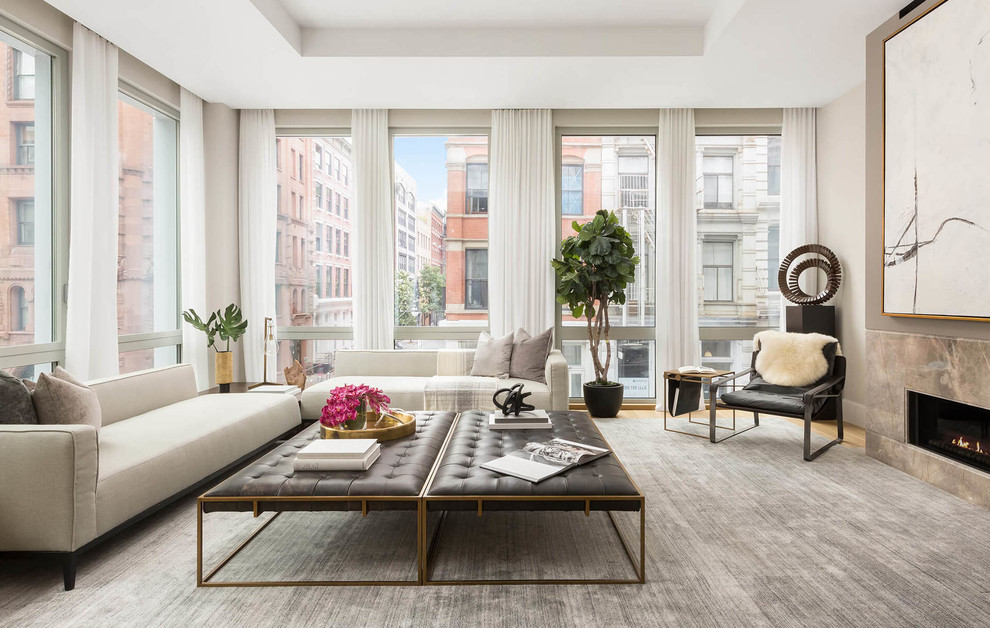 Living room - contemporary light wood floor and brown floor living room idea in New York with beige walls and a ribbon fireplace