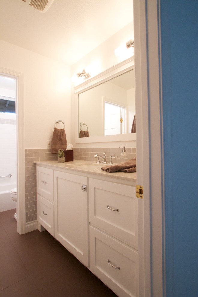 Inspiration for a traditional bathroom in San Diego with an undermount sink, shaker cabinets, white cabinets, engineered quartz benchtops, an alcove tub, an alcove shower, a one-piece toilet, gray tile, ceramic tile, white walls and porcelain floors.