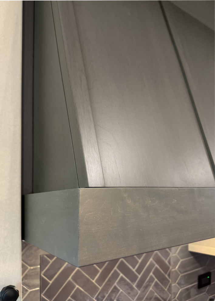 Eat-in kitchen - large transitional porcelain tile and gray floor eat-in kitchen idea in Chicago with a farmhouse sink, recessed-panel cabinets, light wood cabinets, quartz countertops, gray backsplash, porcelain backsplash, an island and white countertops