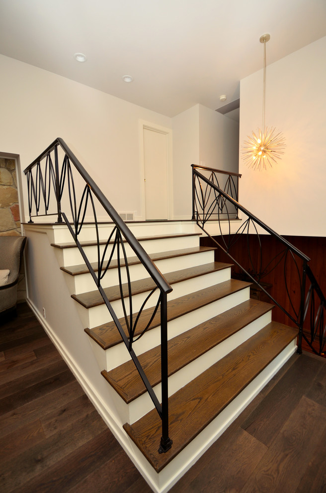 Photo of a mid-sized transitional wood straight staircase in Cleveland with concrete risers.