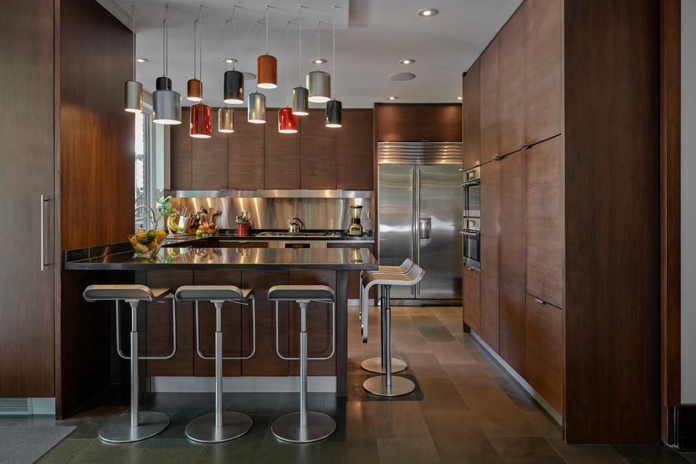 Design ideas for a mid-sized contemporary u-shaped kitchen in Toronto with flat-panel cabinets, dark wood cabinets, stainless steel benchtops, metallic splashback, metal splashback, stainless steel appliances, a double-bowl sink and ceramic floors.