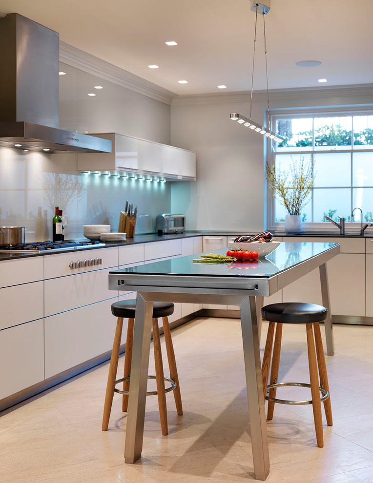 Inspiration for a contemporary kitchen in Wiltshire with flat-panel cabinets, white cabinets, stainless steel benchtops and glass sheet splashback.
