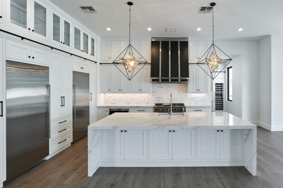 Example of a transitional kitchen design in Phoenix with shaker cabinets and white cabinets