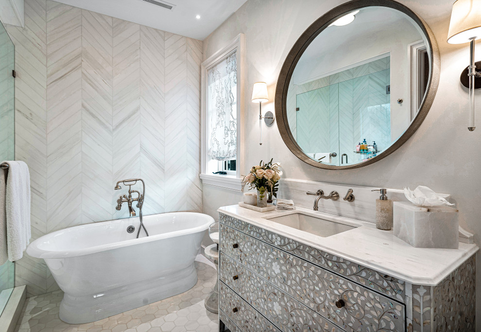 This is an example of an expansive classic grey and white wet room bathroom in Miami with freestanding cabinets, grey cabinets, a freestanding bath, a one-piece toilet, white tiles, marble tiles, beige walls, marble flooring, a submerged sink, marble worktops, white floors, a hinged door, white worktops, a single sink, a built in vanity unit and wallpapered walls.