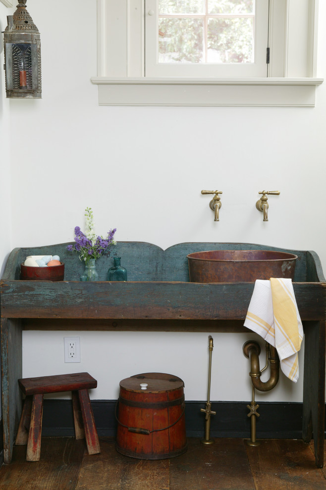 Photo of a country powder room in Philadelphia with a vessel sink and blue cabinets.