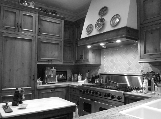 Example of a small u-shaped kitchen design with flat-panel cabinets, medium tone wood cabinets, granite countertops and an island