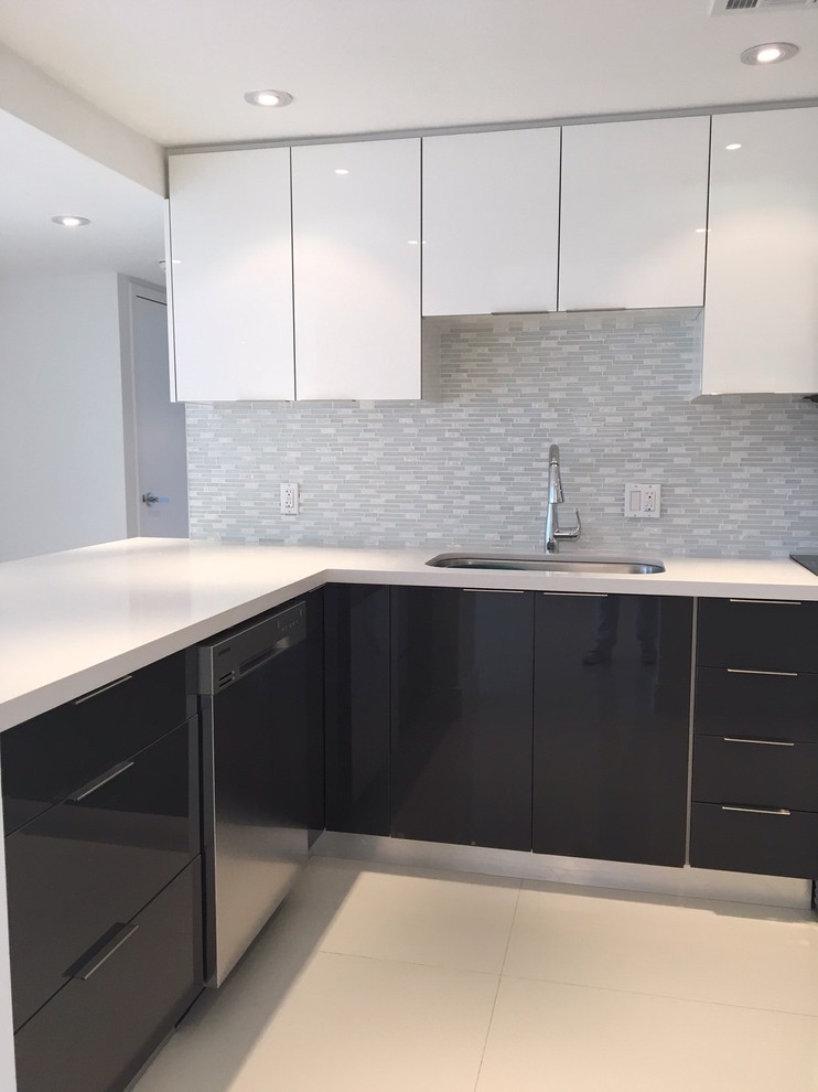 Dark gray kitchen. Stone and glass backsplash