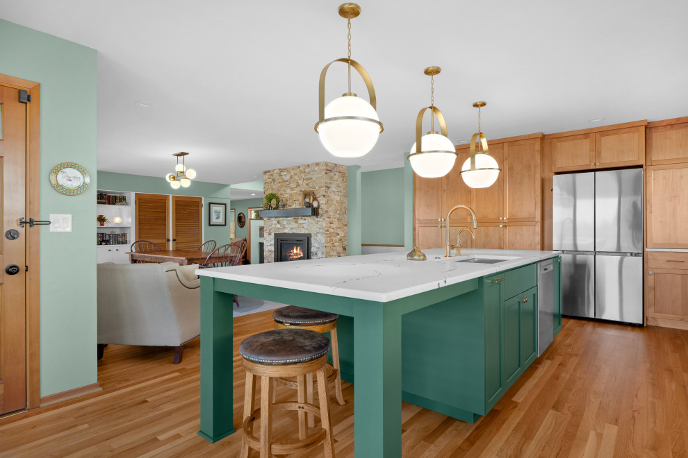 Example of a transitional l-shaped medium tone wood floor kitchen design with shaker cabinets, white backsplash, an island and white countertops