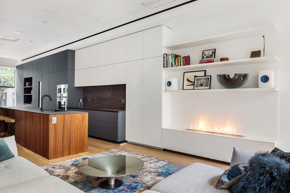 Large trendy light wood floor and beige floor living room photo in New York