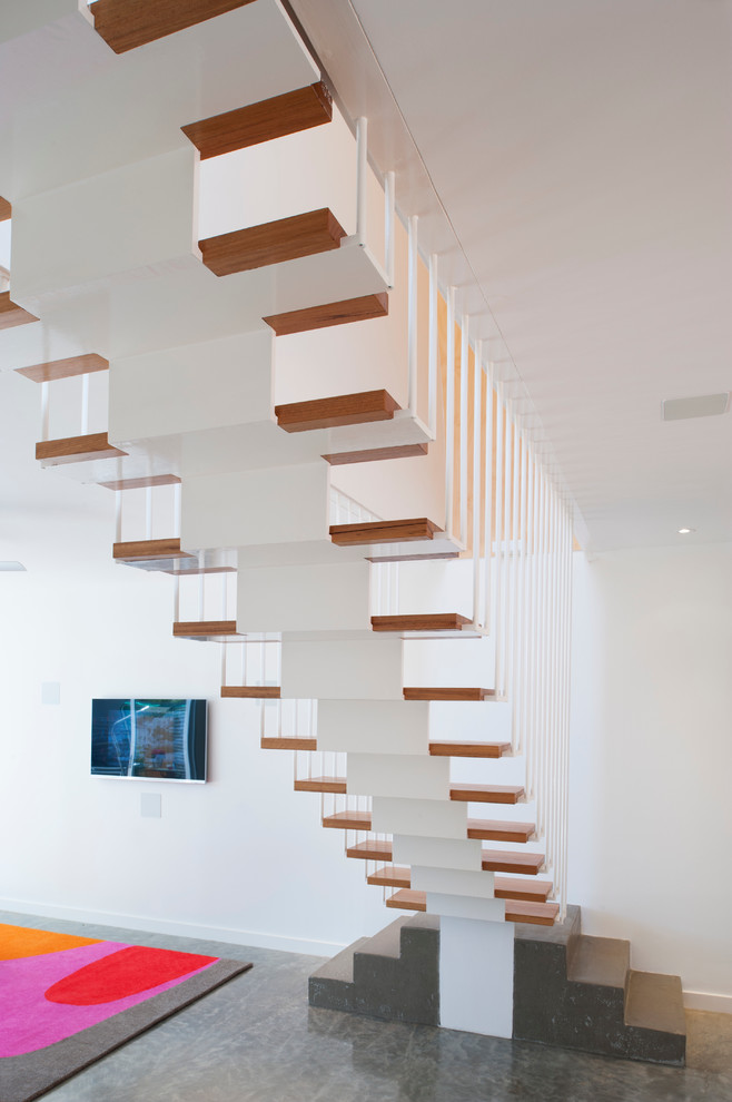 Design ideas for a contemporary wood straight staircase in New York with open risers.