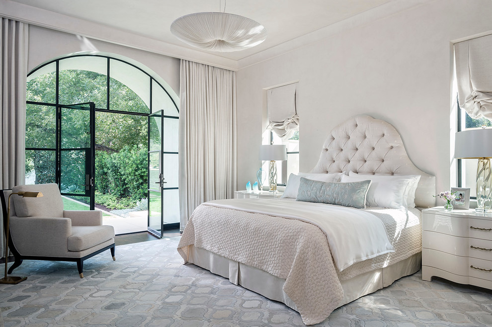 This is an example of a mediterranean bedroom in Austin with white walls and dark hardwood floors.