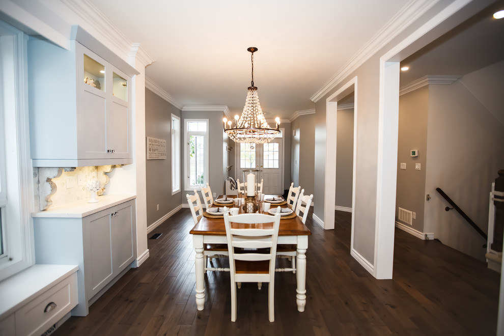 Example of a mid-sized transitional galley dark wood floor eat-in kitchen design in Toronto with an undermount sink, shaker cabinets, white cabinets, granite countertops, white backsplash, stone tile backsplash, stainless steel appliances and an island