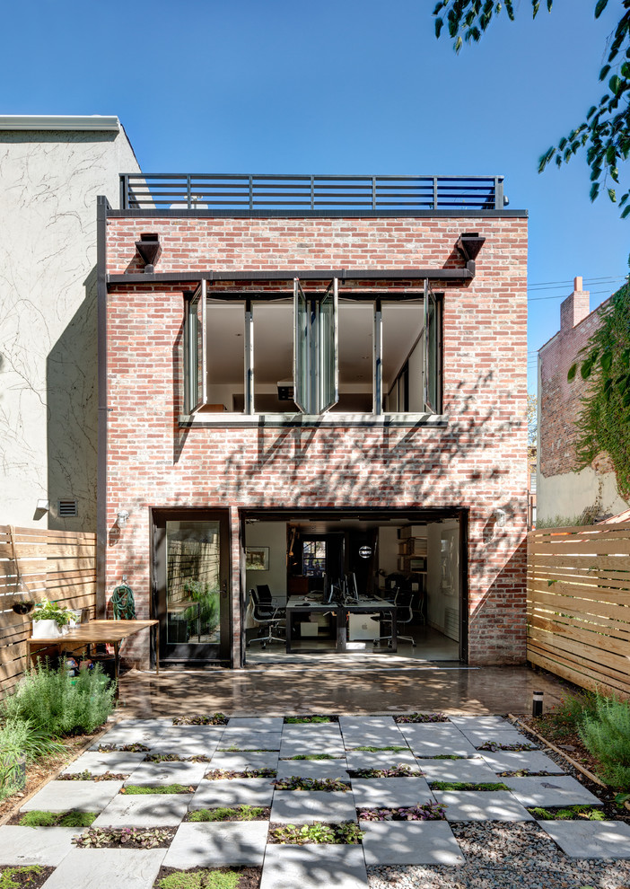 Inspiration for a mid-sized contemporary backyard partial sun formal garden for spring in New York with a container garden and concrete pavers.