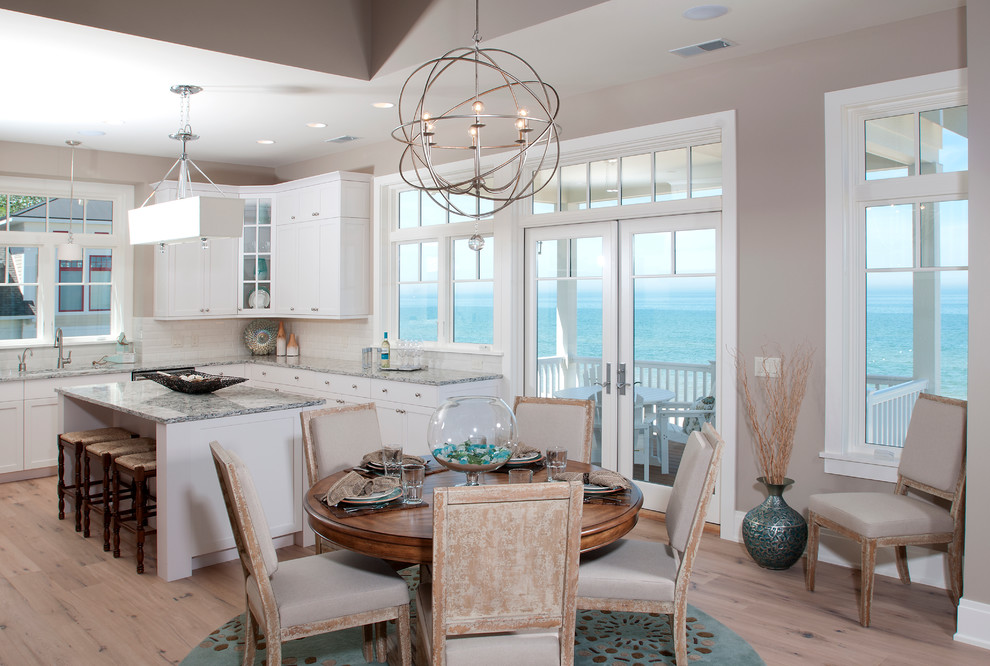 Beach style kitchen/dining combo in Grand Rapids with beige walls and medium hardwood floors.