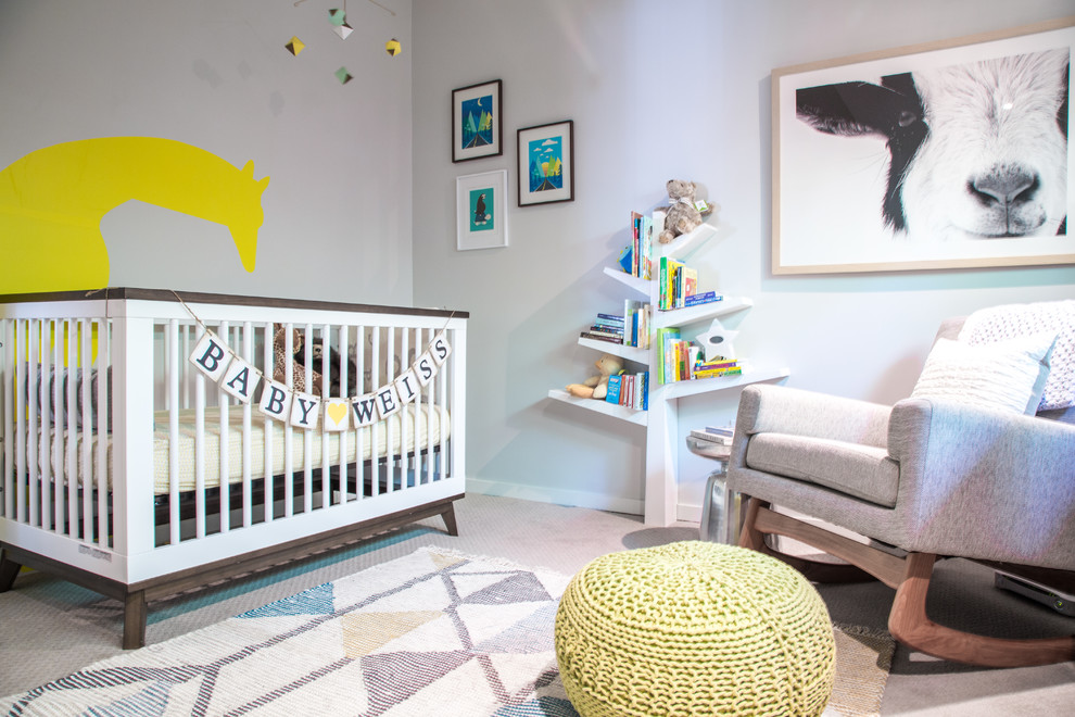 This is an example of a transitional gender-neutral nursery in Los Angeles with grey walls, carpet and beige floor.