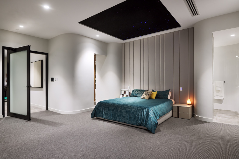 Photo of a large contemporary master bedroom in Perth with white walls, carpet and grey floor.