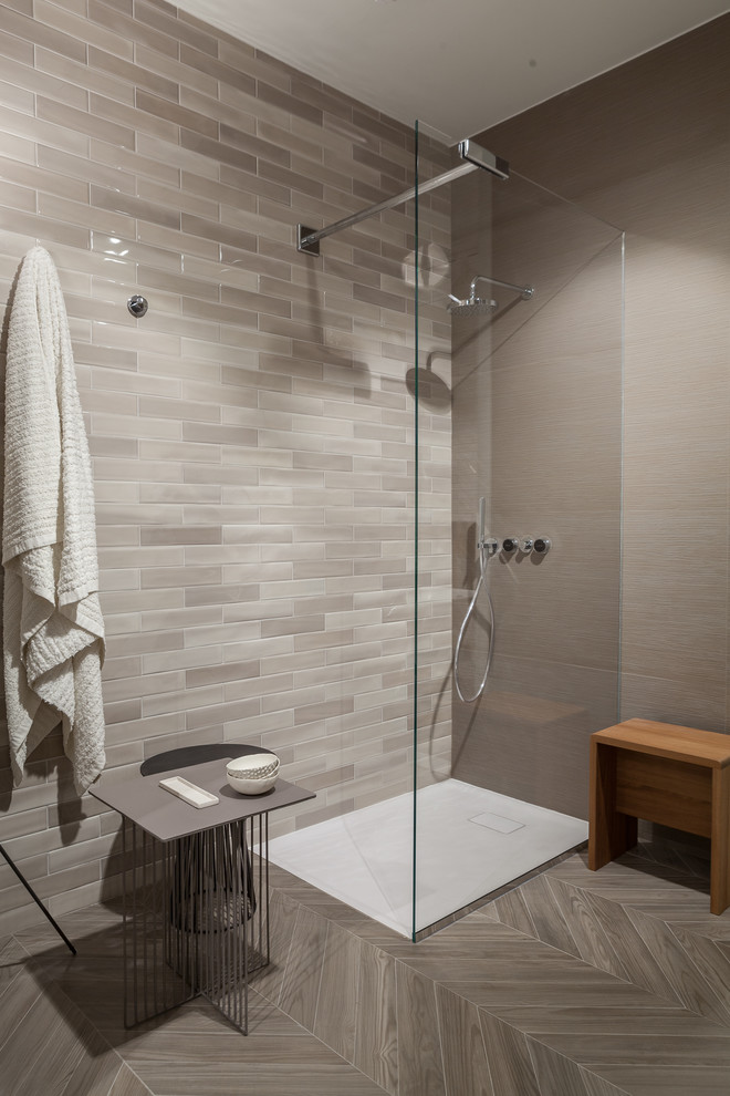 This is an example of a mid-sized modern master bathroom in Toronto with open cabinets, light wood cabinets, an open shower, a one-piece toilet, beige tile, porcelain tile, beige walls, porcelain floors and solid surface benchtops.