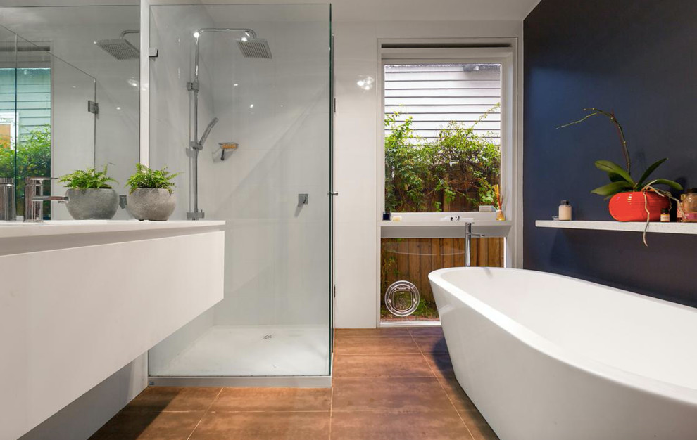 Photo of a mid-sized modern bathroom in Melbourne with black walls, ceramic floors and brown floor.
