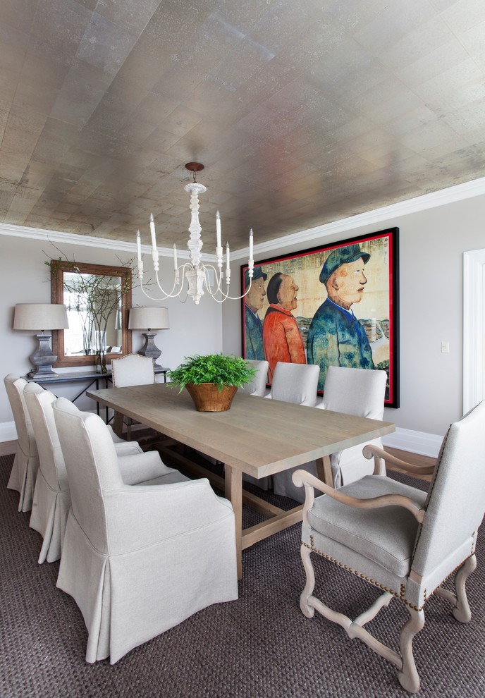This is an example of a large beach style separate dining room in New York with grey walls, light hardwood floors and beige floor.