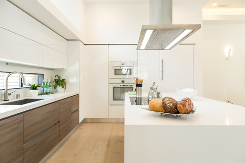 Premade kitchen cabinet design with modern European-style cabinetry, integrated bar seating, and smooth contemporary lines.