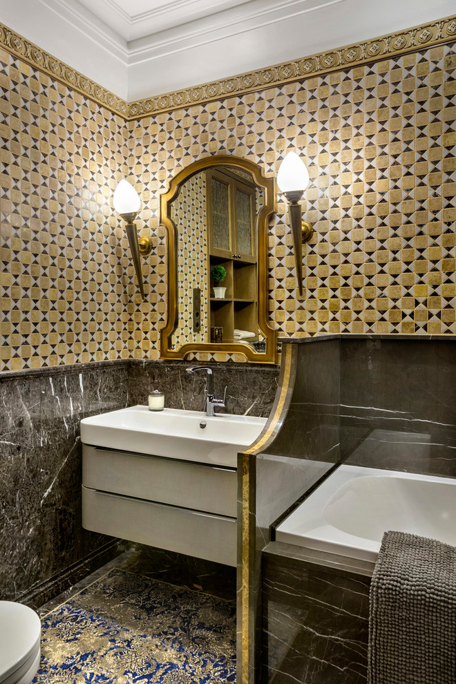 Inspiration for a mid-sized traditional master bathroom in Moscow with a hot tub, a wall-mount toilet, marble, marble floors, grey floor, flat-panel cabinets, white cabinets, yellow tile, gray tile, a shower/bathtub combo, an integrated sink and a shower curtain.