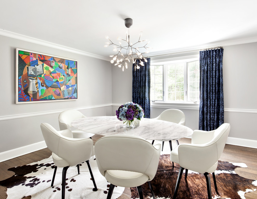 Photo of a contemporary dining room in New York with medium hardwood floors.