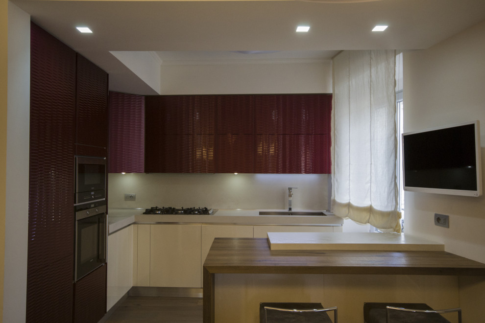 Medium sized contemporary l-shaped kitchen/diner in Other with a submerged sink, red cabinets, tile countertops, dark hardwood flooring, an island, beige worktops and a coffered ceiling.