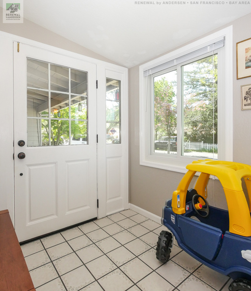 Design ideas for a mid-sized mudroom in San Francisco with beige walls, ceramic floors, a single front door, a white front door, beige floor and vaulted.
