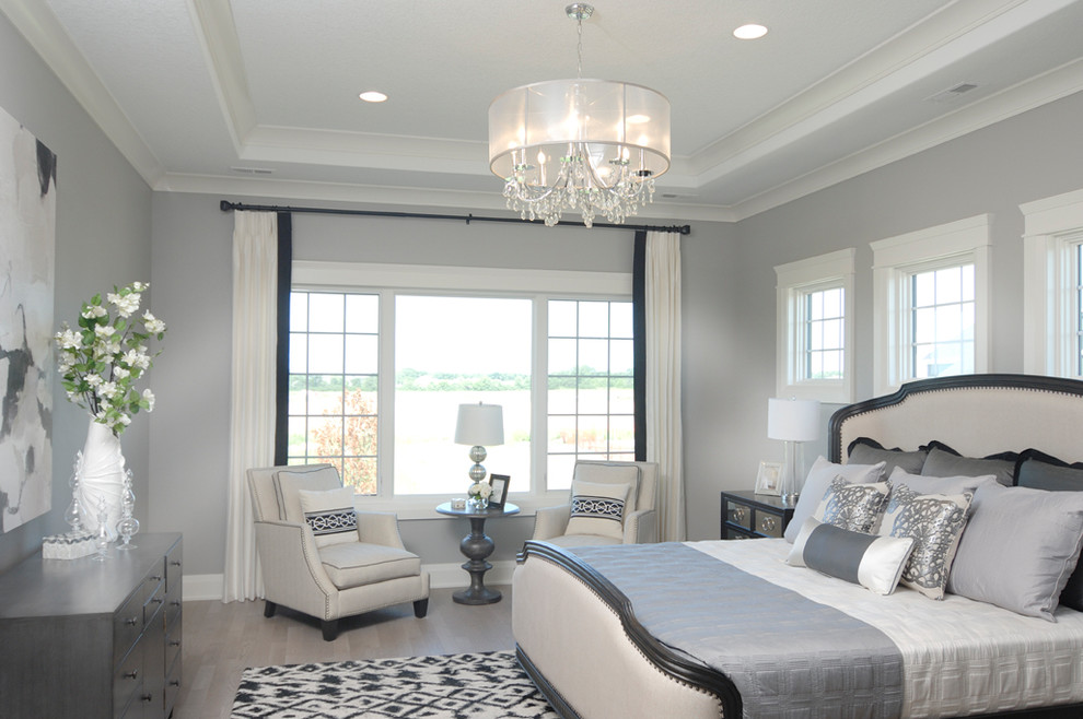 Inspiration for a mid-sized transitional master light wood floor bedroom remodel with gray walls and no fireplace