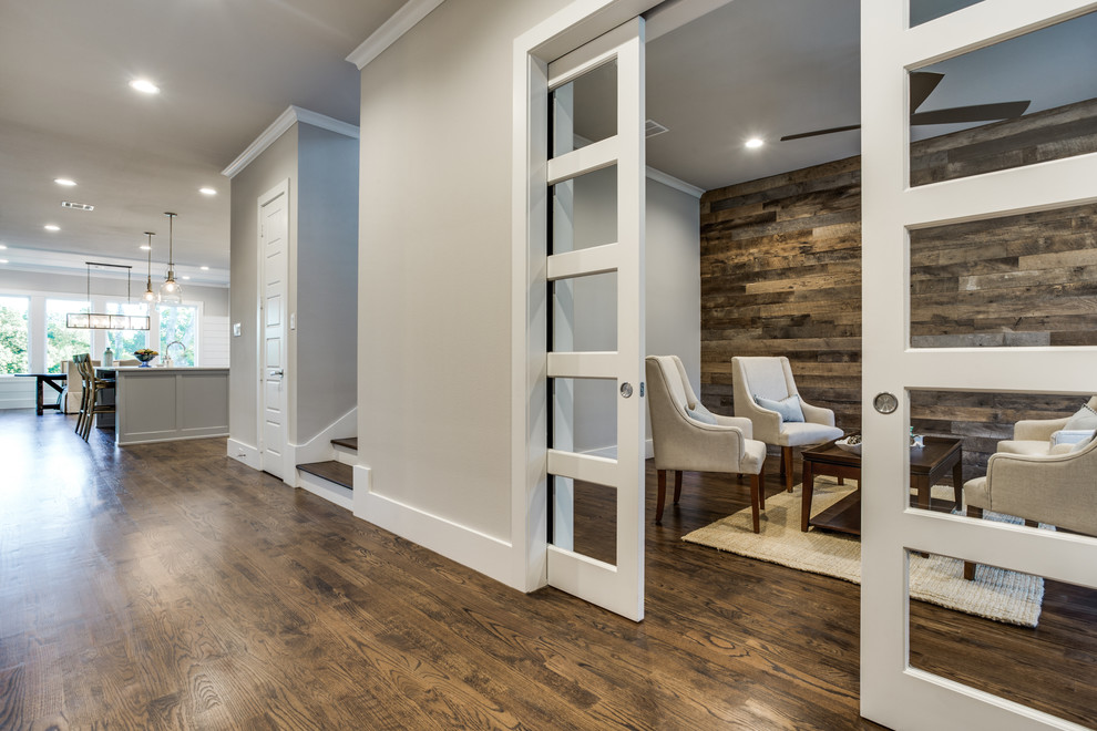 Inspiration for a mid-sized country foyer in Dallas with grey walls, medium hardwood floors, a single front door and a medium wood front door.