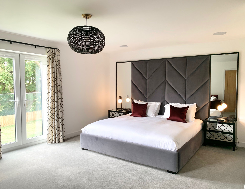 Design ideas for a large contemporary master bedroom in Hertfordshire with white walls, carpet and grey floor.
