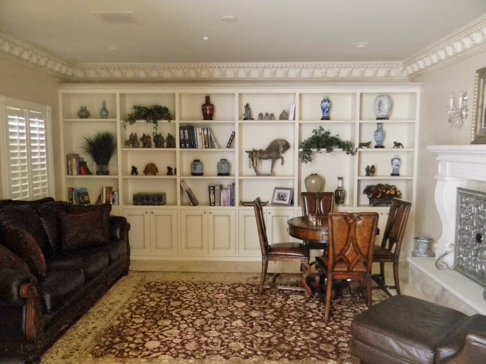 This is an example of a small traditional enclosed family room in Phoenix with a game room, beige walls, a standard fireplace, a stone fireplace surround, no tv and carpet.