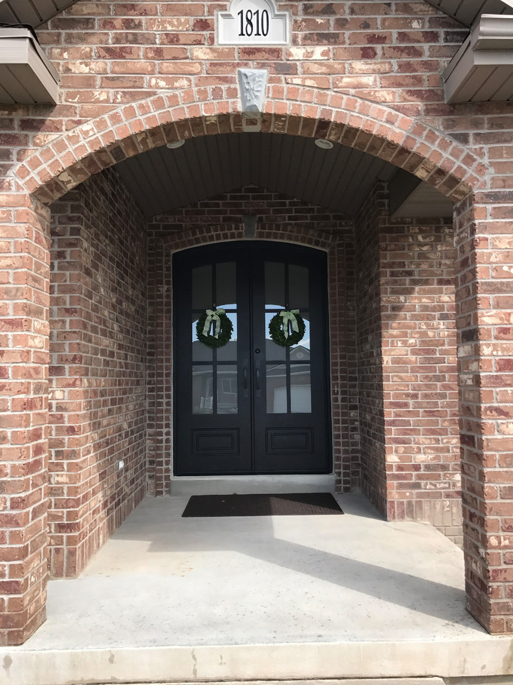 Inspiration for a small traditional front door in Salt Lake City with red walls, concrete floors, a double front door, a black front door and grey floor.