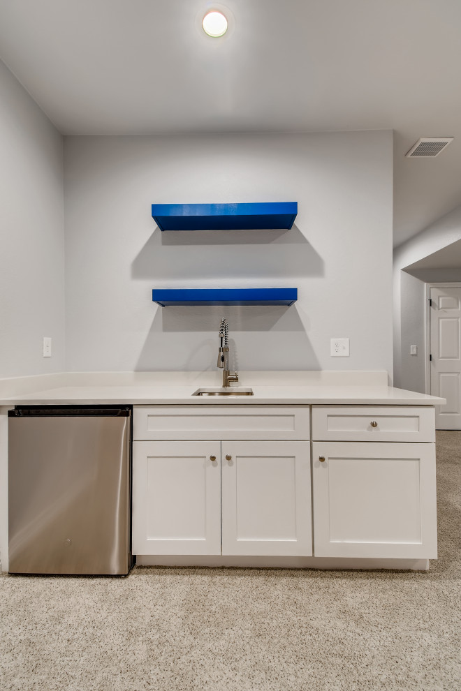 Photo of a small contemporary single-wall wet bar in Denver with recessed-panel cabinets, white cabinets, carpet, grey floors and white worktops.