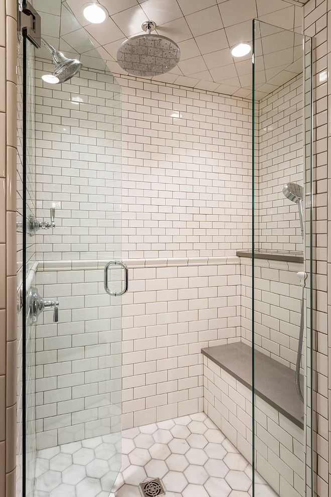 This is an example of a mid-sized transitional master bathroom in Minneapolis with shaker cabinets, white tile, subway tile, white walls, marble floors, engineered quartz benchtops, white floor and a hinged shower door.