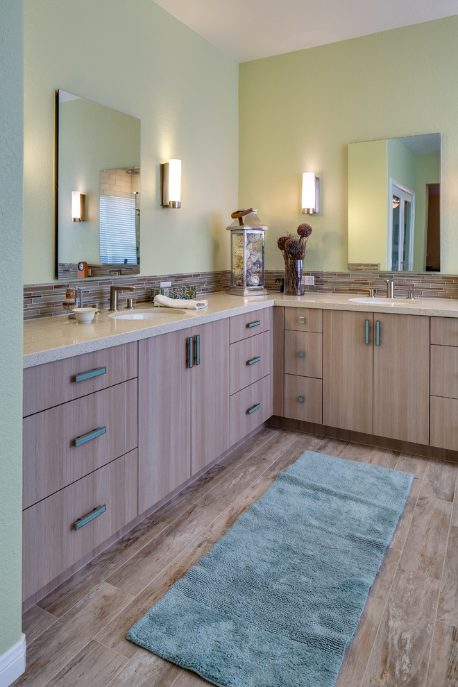 This is an example of a mid-sized transitional master bathroom in San Diego with an integrated sink, flat-panel cabinets, light wood cabinets, engineered quartz benchtops, beige tile, matchstick tile, green walls and porcelain floors.
