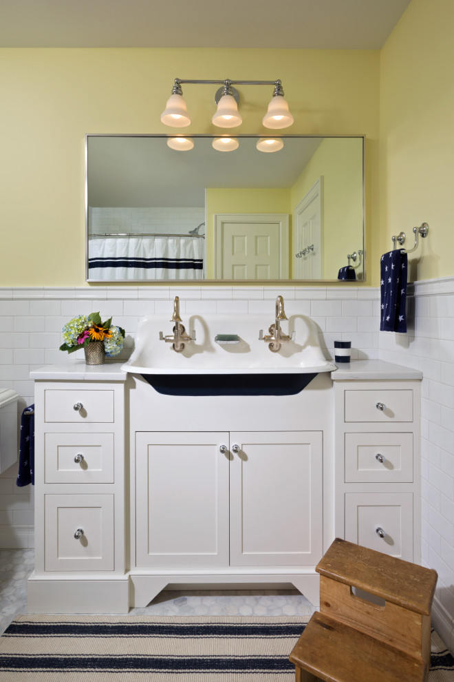 Mid-sized traditional kids bathroom in Boston with white cabinets, a shower/bathtub combo, white tile, subway tile, yellow walls, marble floors, a drop-in sink, grey floor, a shower curtain, white benchtops, a single vanity, a freestanding vanity, quartzite benchtops and shaker cabinets.
