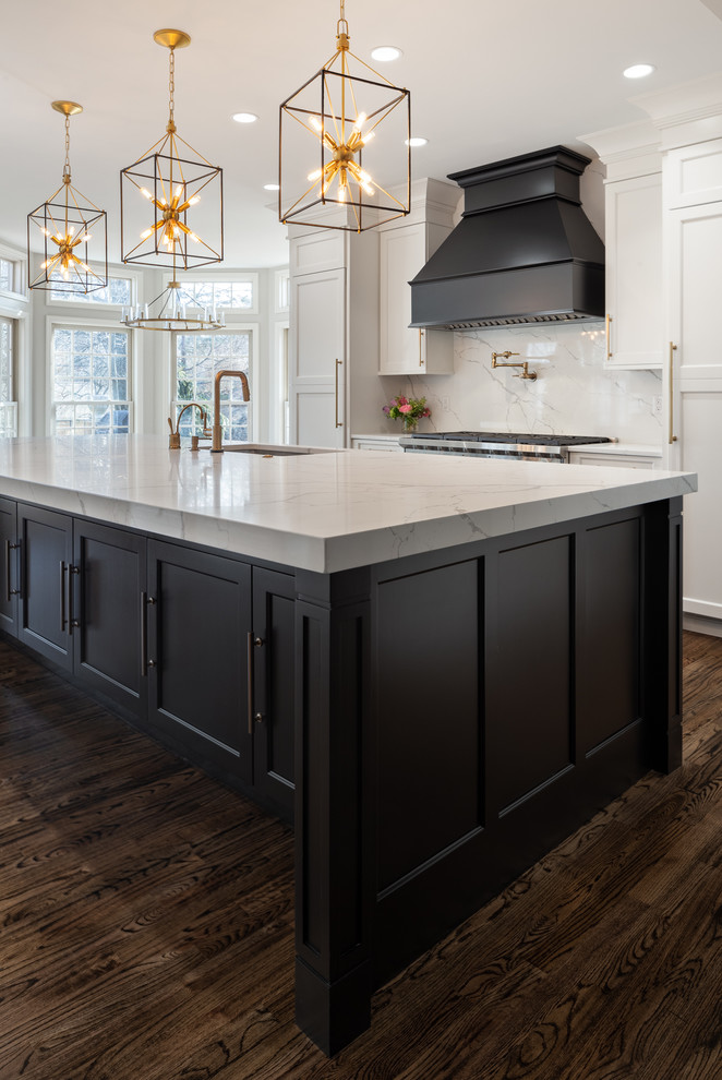 Inspiration for a large transitional dark wood floor and brown floor kitchen remodel in Other with an undermount sink, white cabinets, quartz countertops, white backsplash, stone slab backsplash, stainless steel appliances, an island, white countertops and shaker cabinets