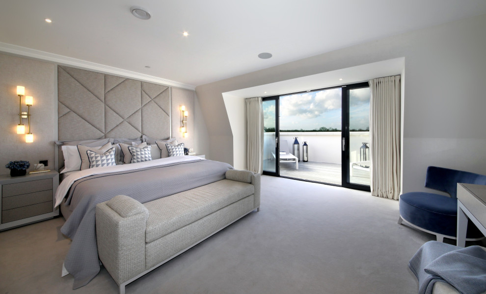 Photo of a large contemporary master bedroom in London with grey walls, carpet and grey floor.