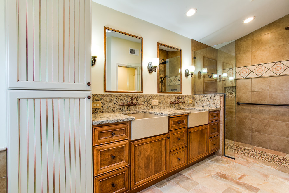 Inspiration for a large mediterranean master bathroom in DC Metro with beaded inset cabinets, brown cabinets, a claw-foot tub, a curbless shower, a one-piece toilet, beige tile, stone slab, beige walls, ceramic floors, an undermount sink, engineered quartz benchtops, multi-coloured floor and a hinged shower door.
