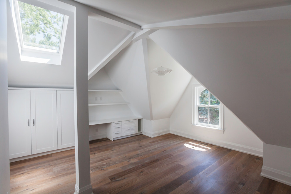 This is an example of a mid-sized transitional loft-style bedroom in Toronto with white walls and medium hardwood floors.